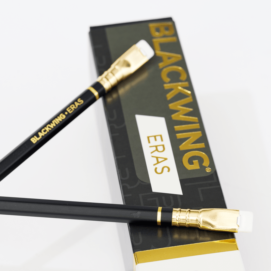 Two black and gold pencils with a box labeled 'BLACKWING ERAS' on a white background.