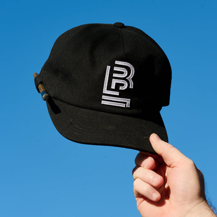 Black cap with a white embroidered Blackwing emblem on the front and pencil loop on the side