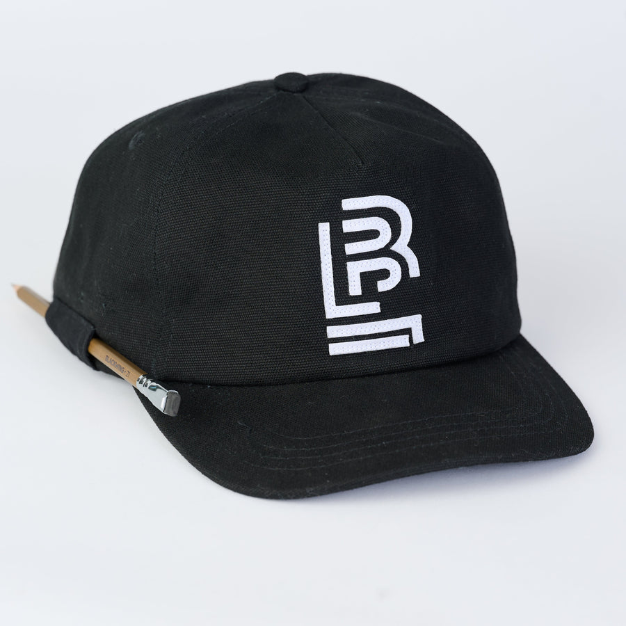 Black cap with a white embroidered Blackwing emblem, featuring a pencil loop on the side to hold a Blackwing pencil