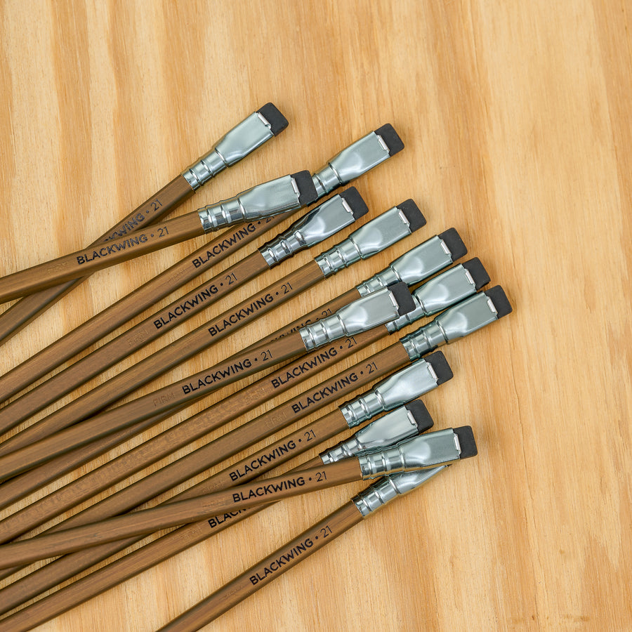 Multiple Blackwing Volume 21 pencils arranged on a wooden surface