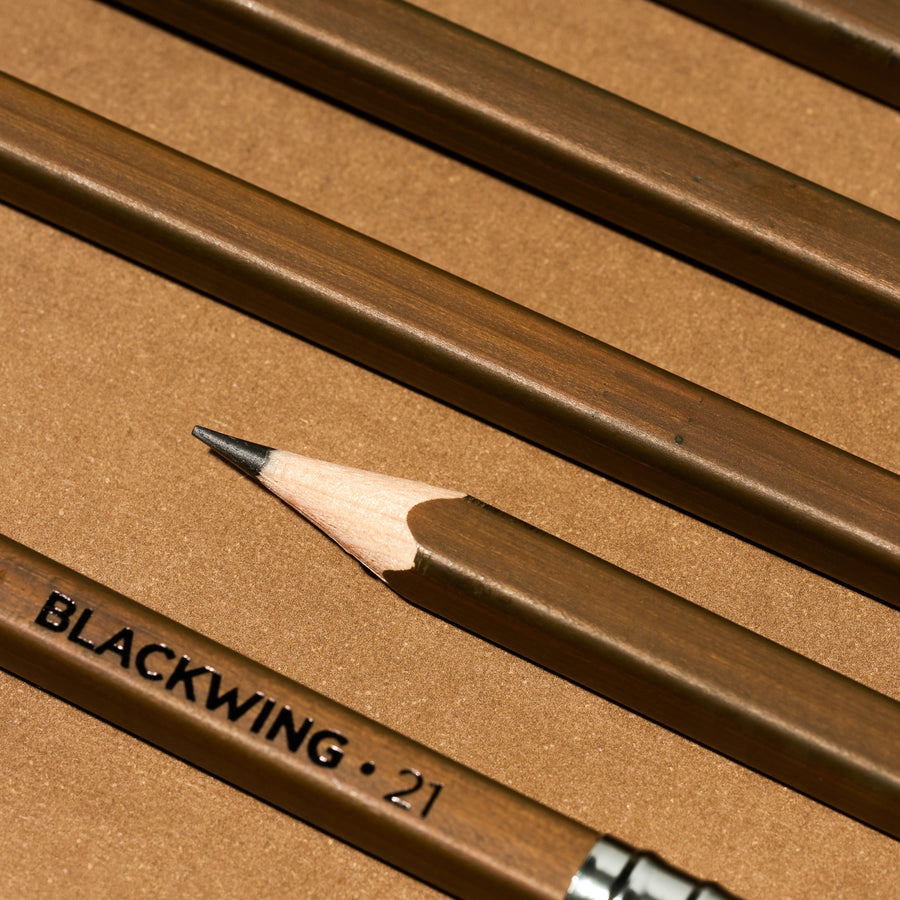 Close-up of a Blackwing 21 pencil on a brown background