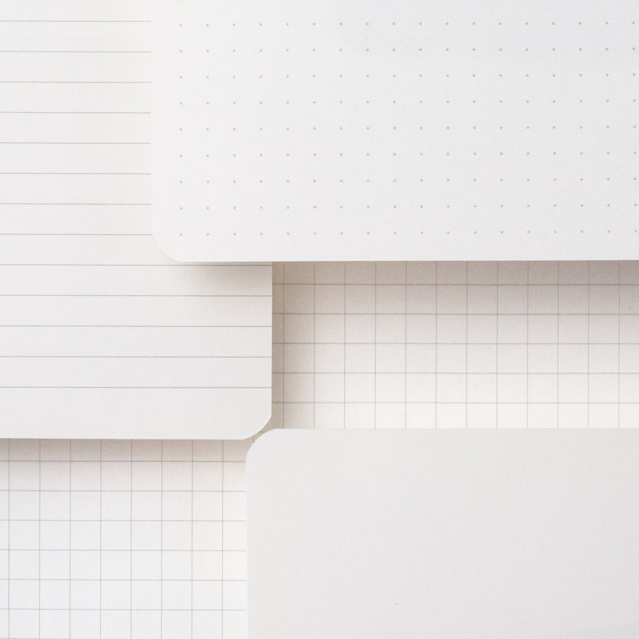 A stack of Medium Blackwing Slate Notebooks with 100 GSM ivory paper on a white surface.